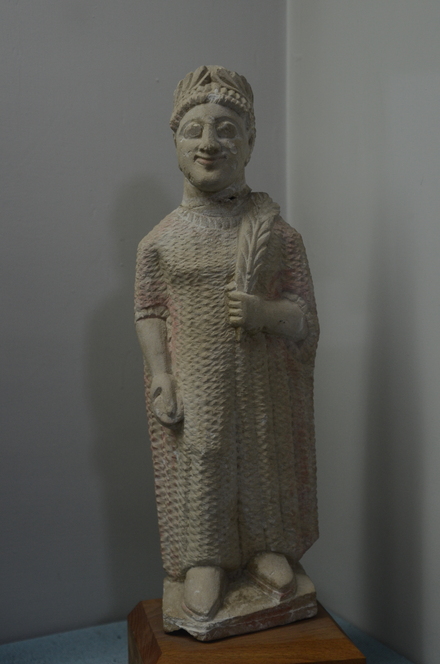 Terracotta statue of a votary wearing a chiton and a wreath
