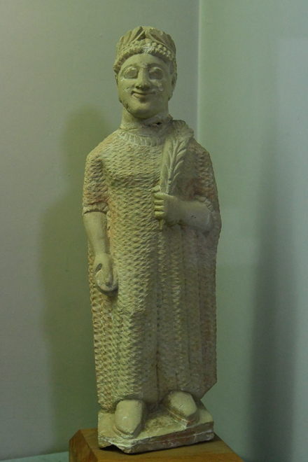 Terracotta statue of a votary wearing a chiton and a wreath