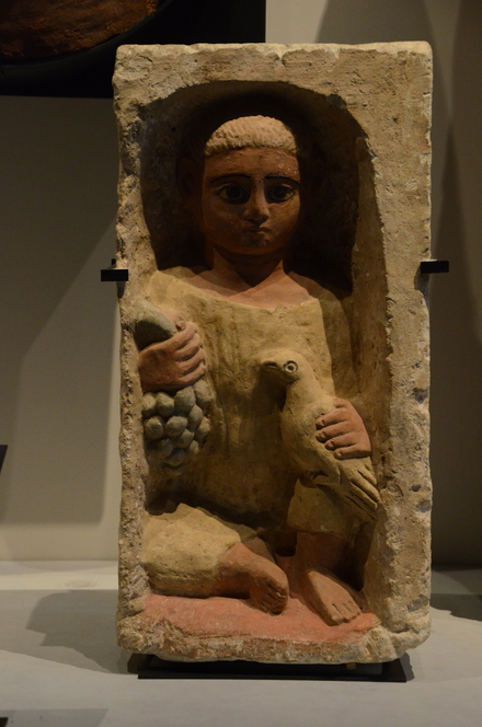 Antinopolis, Stele of boy with grapes in one hand and a dove in the other