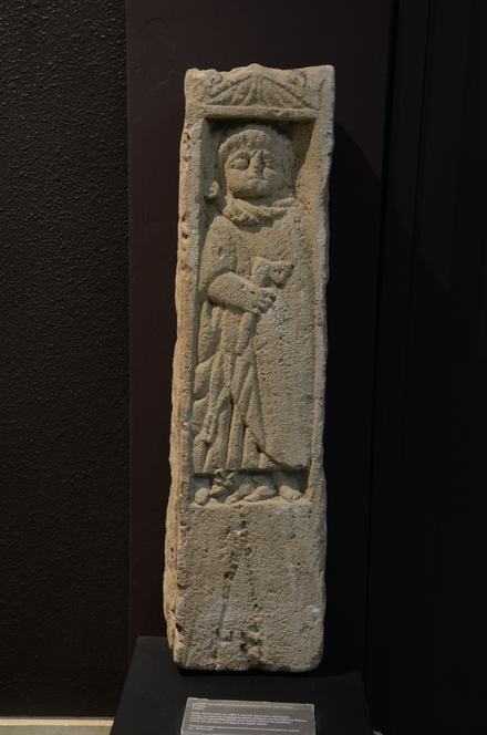 Grand, Stele with kid with ax and dog