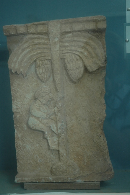 Relief of a peasant climbing a palm tree