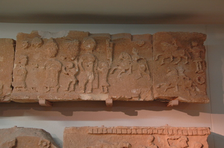 Relief of a mausoleum: family and cavalry
