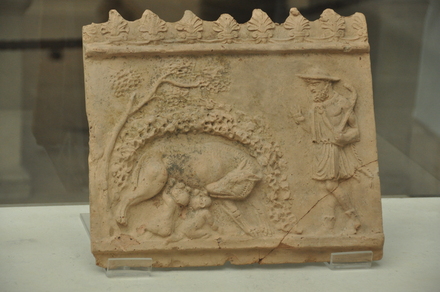 Relief with Faustulus and Remus and Romulus drinking milk from  the wolf