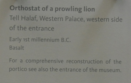 Tell Halaf, Orthostat seated figure holding lotus flower, winged sun disc supported by two bull-menfound south wall of temple palace
