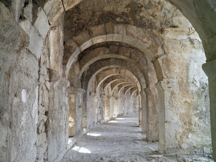 Vaulted arched walkway running around the top of semi-circular cavea of the Roman theatre