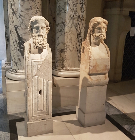 Two herms with the bearded head of a divinity (Hermes?)