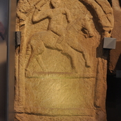 Tombstone showing man on mule