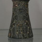 Jiroft, Conical vase of chlorite, with male figures holding snakes