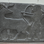 Tell Halaf, West palace entrance, orthostat of a winged sun disk, supported by two bull-man and a kneeling man with three lines of cuneiform inscription