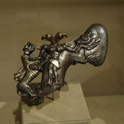 Axe in the shape of a two-headed demon, mastering a boar and a dragon