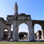 The Roman Amphitheatre, exterior archways faced with marble and decorated with marble figure heads of Artemis and Hera