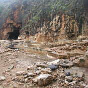 Panias cave and remains of the temple in front .
