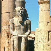 Sitting Ramzes II in Luxor Temple of the Theban Triad